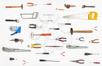 many hand tools arranged on white background