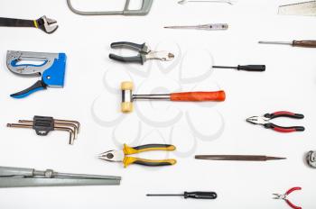 various hand tools arranged on white background