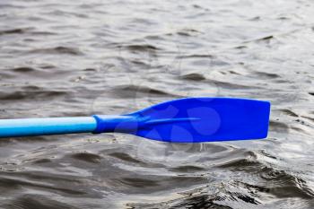 oar blade over the water during rowing boat on lake