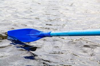 paddle blade in water during boating on the lake