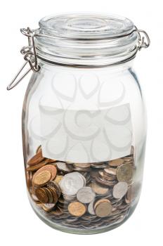 closed glass jar with empty label and saved coins isolated on white background
