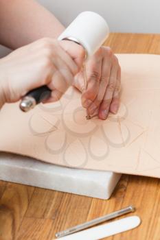 leathercraft - craftsman puts embossing on leather