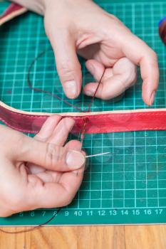 leather-working - craftsman sews new leather belt