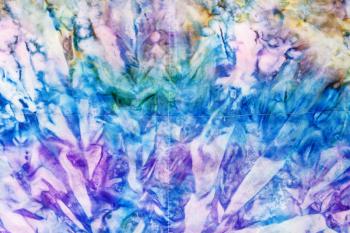 textile background - abstract blue and violet colored stitched silk batik