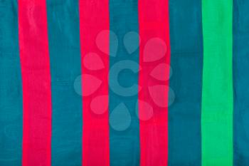 textile background - striped silk cloth with red, blue, green stripes