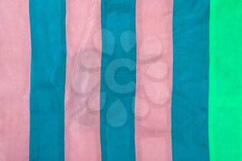 textile background - striped silk cloth with pink, blue, green stripes