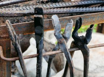 forge tongs in country outdoor blacksmith on backyard