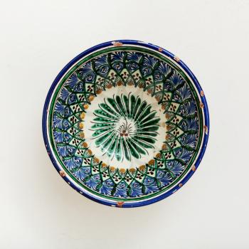 top view of traditional central asian bowl on white plastering plate