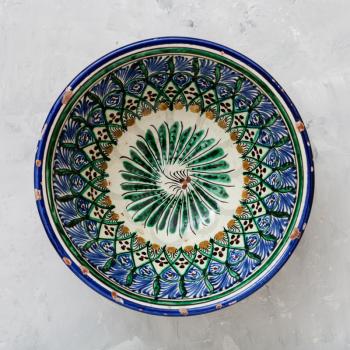 above view of typical central asian bowl on gray concrete plate