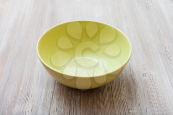 one green bowl on gray brown board