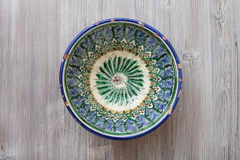 top view of one traditional central asian bowl on gray brown table