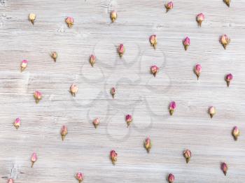 many natural pink rose flower buds on wooden table