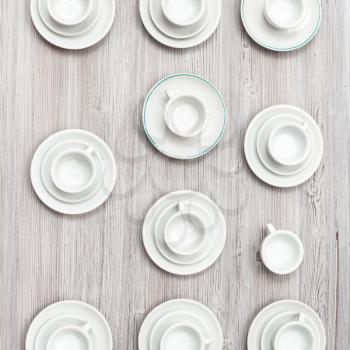 food concept - top view of several cups and saucers on gray brown table