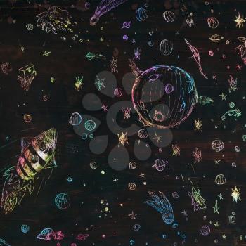 illustration drawn by hand with wax and pastel - spaceship, stars and comet in dark space