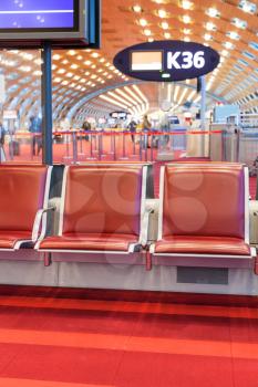 empty red seat in departure area of airport