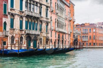 travel to Italy - wet gondolas near houses in Grand Canal in Venice in rainy autumn day
