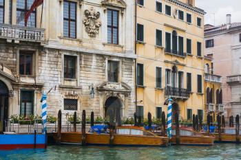 travel to Italy - mooring of water taxi near houses in Canal in Venice in rainy autumn day