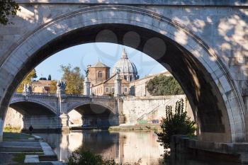 travel to Italy - view of Borgo district with dome of St. Peter's Basilica and bridge Ponte Vittorio Emanuele II from Tiber river in Rome