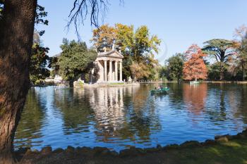 travel to Italy - walking boats on pond near Temple of Aesculapius in Villa Borghese public gardens in Rome city in autumn