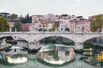 travel to Italy - Rome city skyline with Tiber River, and bridge Ponte Vittorio Emanuele II in evening twilight