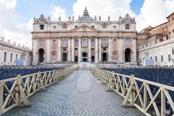 travel to Italy - square piazza San Pietro with chairs and view of Papal Basilica of St Peter in Vatican city
