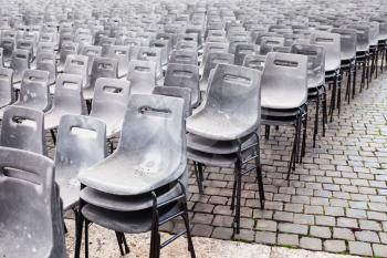 travel to Italy - many old empty plastic chairs on St Peter square in Vatican city