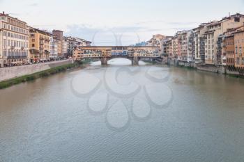 travel to Italy - Arno River with Ponte Vecchio (Old Bridge) in Florence city in evening twilight