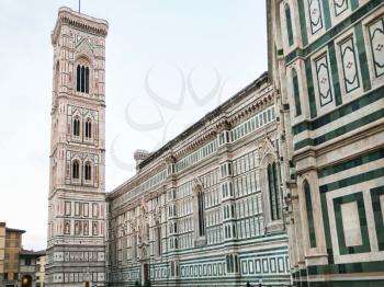 travel to Italy - view of Giotto's Campanile and Florence Duomo Cathedral (Cattedrale Santa Maria del Fiore, Cathedral of Saint Mary of the Flowers) from Piazza del Duomo in Florence city in morning