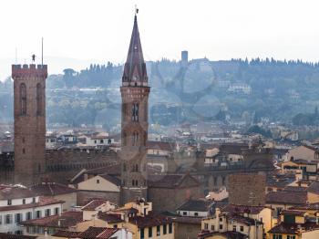 travel to Italy - above view towers of Badia Fiorentina Fraternity of Jerusalem abbey in Florence city from Campanile