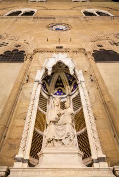 travel to Italy - facade of medieval Orsanmichele church with statue (Madonna of the Rose by sculptor Pietro di Giovanni Tedesco) in Florence city in night