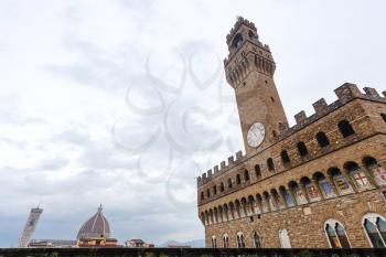 travel to Italy - view of Palazzo Vecchio and Cathedral dome in rain in Florence city