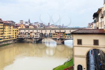 travel to Italy - view of Ponte Vecchio (Old bridge) and Arno river in Florence city in autumn rainy day