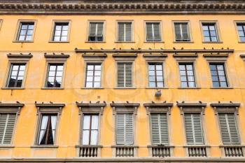 travel to Italy - yellow facade of old apartment house in Florence city