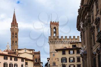 travel to Italy - towers of Badia Fiorentina and Bargello palace over houses in Florence city
