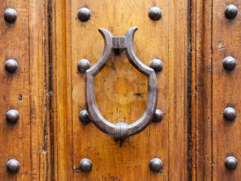 travel to Italy - medieval knocker on old door in Florence city
