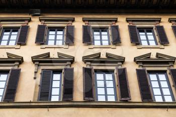 travel to Italy - windows on facade of old house in Florence city