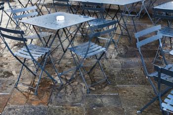 travel to Italy - wet tables in street restaurant in Florence city after autumn rain