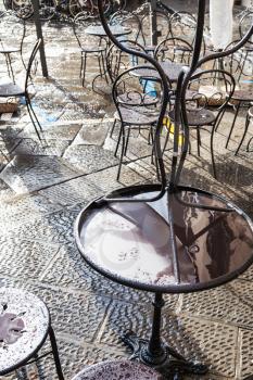 travel to Italy - wet tables in street cafe in Florence city after rain