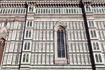 travel to Italy - view of ornamental wall of Florence Duomo Cathedral (Cattedrale Santa Maria del Fiore, Duomo di Firenze, Cathedral of Saint Mary of the Flowers) from Piazza del Duomo in Florence