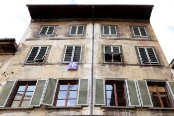 travel to Italy - facade of old house with pennant with the coat of arms of Florence in Florence city