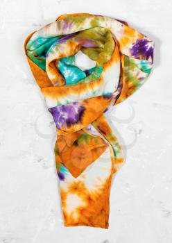 tied hand painted silk scarf on concrete plate