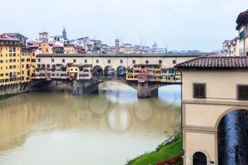 travel to Italy - view of Ponte Vecchio and Arno river in Florence in autumn rain