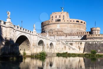travel to Italy - view of Castel Sant'Angelo (Castle of Holy Angel, Mausoleum of Hadrian) and St Angel bridge in Rome city from Tiber river waterfront in sunny day