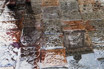 travel to Italy - wet stone pavement of on piazza san giovanni near Florence Baptistery in rain