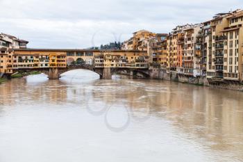 travel to Italy - Ponte Vecchio (Old Bridge) over Arno River and houses on quay in Florence city in autumn