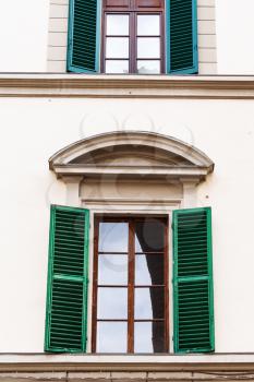 travel to Italy - window with green blinds in urban house in Florence city