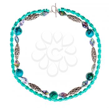 top view of round necklace from chrysocolla natural gem stone balls, artificial turquoise and abalon nacre and silver beads isolated on white background