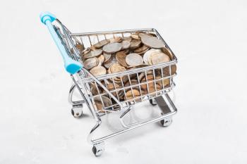 shopping trolley with russian coins on concrete board