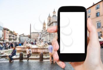 travel concept - tourist photographs square Navona in Rome city on smartphone with cut out screen with blank place for advertising in Italy
