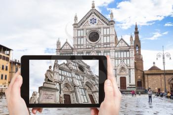 travel concept - tourist photographs Basilica di Santa Croce in Florence city on tablet in Italy